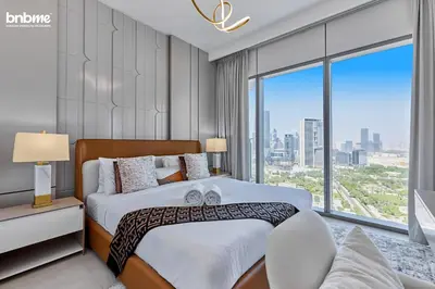 a bedroom with a bed and a large window at bnbmehomes - Downtown Views II in Dubai