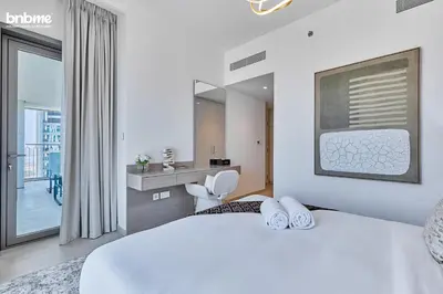 a hotel room with a bed and a bathroom at bnbmehomes - Downtown Views II in Dubai