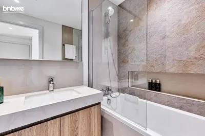 a bathroom with a sink and a shower at bnbmehomes - Downtown Views II in Dubai