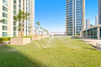 a grassy area in a city with tall buildings at bnbmehomes - Downtown Views II in Dubai
