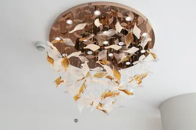 a chandelier with butterflies on a wall at KeyRock - Palm & Sea View Retreat with Pool Access in Dubai