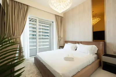 a bedroom with a bed and a large window at KeyRock - Palm & Sea View Retreat with Pool Access in Dubai