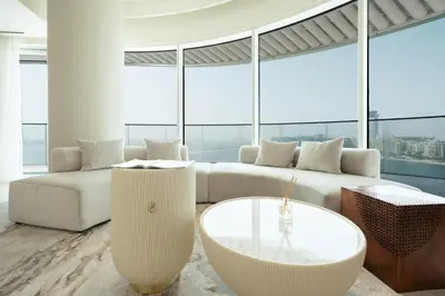 a living room with a white couch and a table at KeyRock - Palm & Sea View Retreat with Pool Access in Dubai