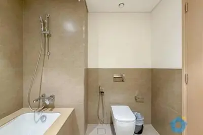 a bathroom with a shower and a toilet and a sink at Next to Burj Khalifa & Dubai Mall - Luxury 2BR with Dubai Skyline Views - Like Home in Dubai