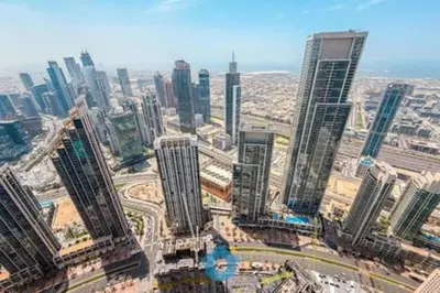 an aerial view of a city with tall buildings at Next to Burj Khalifa & Dubai Mall - Luxury 2BR with Dubai Skyline Views - Like Home in Dubai
