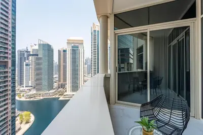 a balcony with a bench and a view of the city at GuestReady - High Floor | Canal View Near Dubai Marina in Dubai