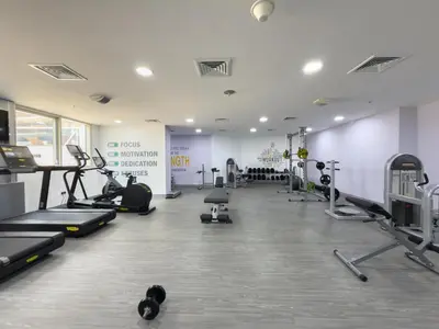 a gym with treadmills and machines in a room at GuestReady - High Floor | Canal View Near Dubai Marina in Dubai