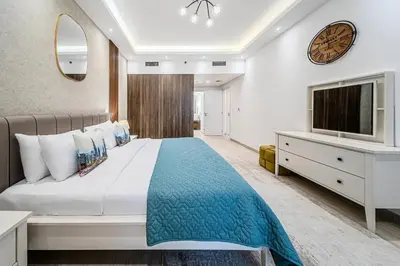 a bedroom with a large bed and a tv at Chic 2BD in Lamtara for 4, Madinat Jumeirah Living in Dubai