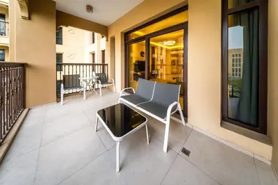 a balcony with a chair and a table at Chic 2BD in Lamtara for 4, Madinat Jumeirah Living in Dubai