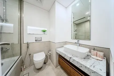 a bathroom with a sink and a toilet and a mirror at Chic 2BD in Lamtara for 4, Madinat Jumeirah Living in Dubai