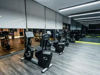 a gym with several rows of exercise equipment in it at Palm Mirage Holiday Homes-2BR With Burj Alarab and City view in Dubai