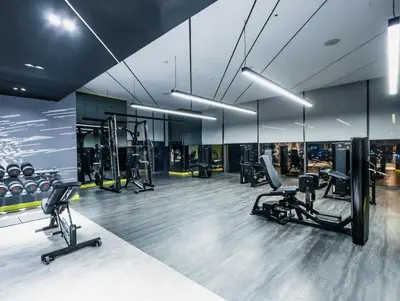a gym with several treadmills and exercise bikes at Palm Mirage Holiday Homes-2BR With Burj Alarab and City view in Dubai