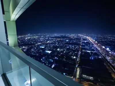 an aerial view of a city at night at Palm Mirage Holiday Homes-2BR With Burj Alarab and City view in Dubai