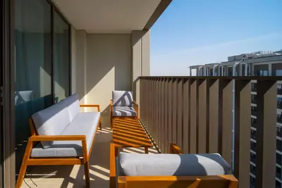a balcony with two chairs and a couch at Ultra Luxuary 2BR - Creek Beach - Serenity Living in Dubai