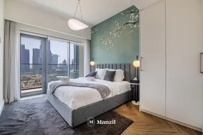 a bedroom with a large bed and a large window at Luxury 2BR Apartment in Downtown with Full Burj Khalifa View in Dubai