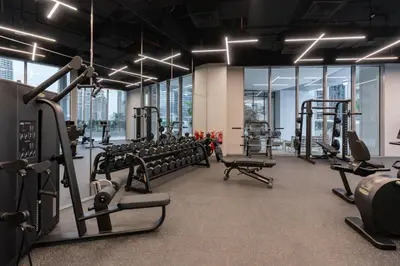 a gym with rows of treadmills and machines at Bespoke Holiday Homes - Luxury 2BR with Stunning Marina Views in LIV Marina in Dubai
