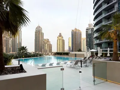 a swimming pool with a city skyline in the background at Bespoke Holiday Homes - Luxury 2BR with Stunning Marina Views in LIV Marina in Dubai