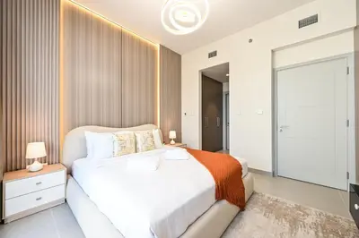 a bedroom with a white bed and a sliding glass door at Luxury 2BR in Downtown 35th Floor 5 min walk Dubai Mall, Gym,Pool, 500mbps Wifi, Forte Tower in Dubai