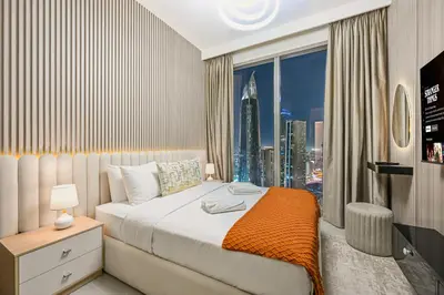 a bedroom with a bed with a view of a city at Luxury 2BR in Downtown 35th Floor 5 min walk Dubai Mall, Gym,Pool, 500mbps Wifi, Forte Tower in Dubai