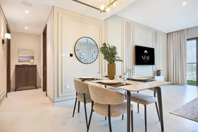 a dining room with a table and chairs at STAY BY LATINEM Luxury 2BR Holiday Home CVG 907 Near Burj Khalifa in Dubai
