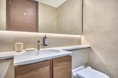 a bathroom with a sink and a toilet and a mirror at STAY BY LATINEM Luxury 2BR Holiday Home CVG 907 Near Burj Khalifa in Dubai