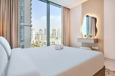a hotel room with a bed and a large window at STAY BY LATINEM Luxury 2BR Holiday Home CVG 907 Near Burj Khalifa in Dubai