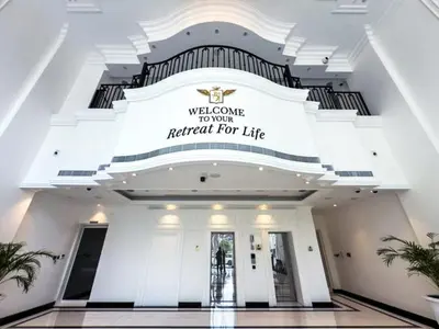a large white building with a welcome to our hotel for life sign at 1BR Lagoon View Luxury Spa Retreat near Miracle Garden in Dubai