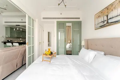 a bedroom with a bed and a table with bananas on it at 1BR Lagoon View Luxury Spa Retreat near Miracle Garden in Dubai