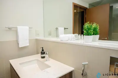 a bathroom with a sink and a mirror at Brand New Modern 2 BR Retreat in Dubai Creek Harbour in Dubai