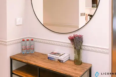 a table with a mirror and a vase on it at Brand New Modern 2 BR Retreat in Dubai Creek Harbour in Dubai