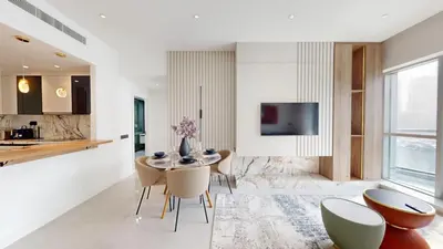 a kitchen and dining room with a table and chairs at The Point - One Bed with Marina Skyline Views in Dubai