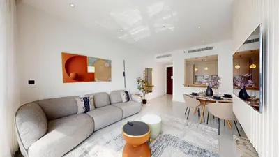 a living room with a couch and a table at The Point - One Bed with Marina Skyline Views in Dubai