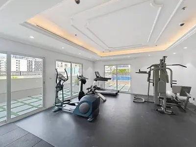 a gym with treadmills and exercise bikes in a room at Al Ghaf - Upgraded One Bed with Pool View in Arjan in Dubai