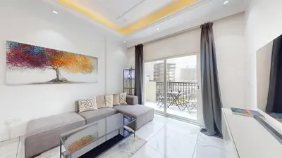 a living room with a couch and a large window at Al Ghaf - Upgraded One Bed with Pool View in Arjan in Dubai