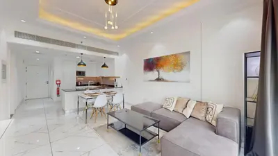 a living room with a couch and a table at Al Ghaf - Upgraded One Bed with Pool View in Arjan in Dubai