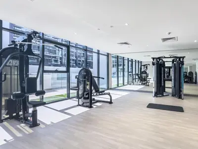 a gym with treadmills and machines in a building at Azizi Riviera - Chic Studio with Balcony in Meydan in Dubai