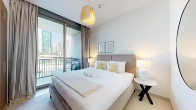 a bedroom with a large bed and a large window at 5242 Tower 2 - One Bed, Low Floor with Canal View in Dubai