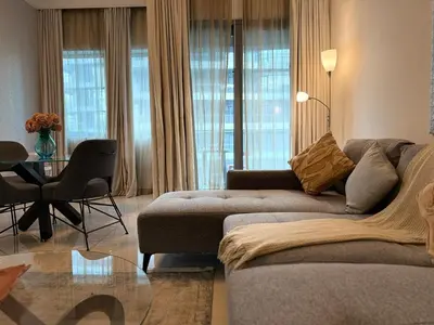 a living room with a couch and a table at ASHRI Luxury apt Steps to Dubai Mall & Burj Khalifa in Dubai