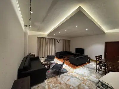 a living room with a couch and a table at Stylish 1BR JBR Beachfront in Dubai