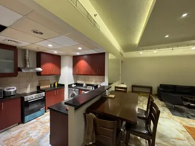 a large kitchen with a table and chairs in it at Stylish 1BR JBR Beachfront in Dubai