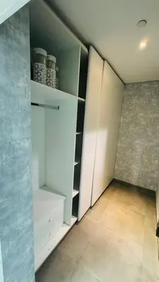 a room with a closet with white cabinets at Modern Homestay Oval Tower, Business Bay in Dubai