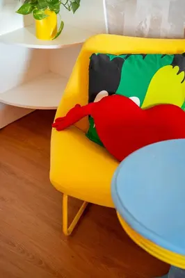 a yellow chair with a red pillow on it at Designer Suite with Skyline views in Dubai