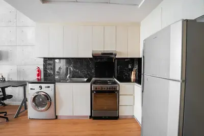 a kitchen with a refrigerator and a stove and a dishwasher at Designer Suite with Skyline views in Dubai