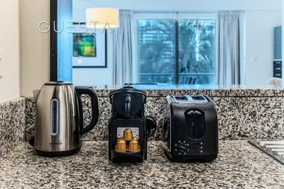 two coffeemakers sitting on a counter in a kitchen at Al Majara 1 BDR plus Guest Bedroom, Dubai Marina in Dubai