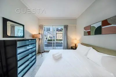 a bedroom with a large white bed and a window at Al Majara 1 BDR plus Guest Bedroom, Dubai Marina in Dubai