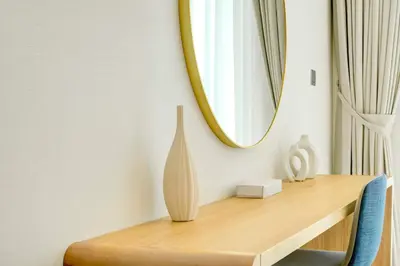 a wooden table with a mirror and a vase on it at TRPS - Farhad Azizi, Al Jaddaf - Premium 1BR, Furnished with Pool View in Dubai
