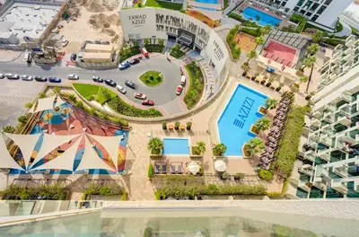 an aerial view of a resort with a pool at TRPS - Farhad Azizi, Al Jaddaf - Premium 1BR, Furnished with Pool View in Dubai