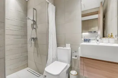a bathroom with a toilet and a shower and a sink at Luxury Apartments in Meydan in Dubai