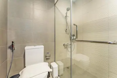 a bathroom with a toilet and a glass shower at Bella Casa - Luxury 1BR Apartment - Brand New Furniture in Dubai