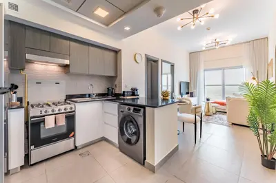 a kitchen with a stove and a dishwasher at Bella Casa - Luxury 1BR Apartment - Brand New Furniture in Dubai